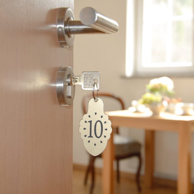 Klucz do apartamentu z góralskim brelokiem, widok na jadalnię, najlepsze noclegi w górach Gorce - wyrazisty apartament studio z prywatną łazienką